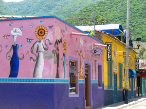Brightly colored homes and businesses abound,  many of them sporting whimsical murals.